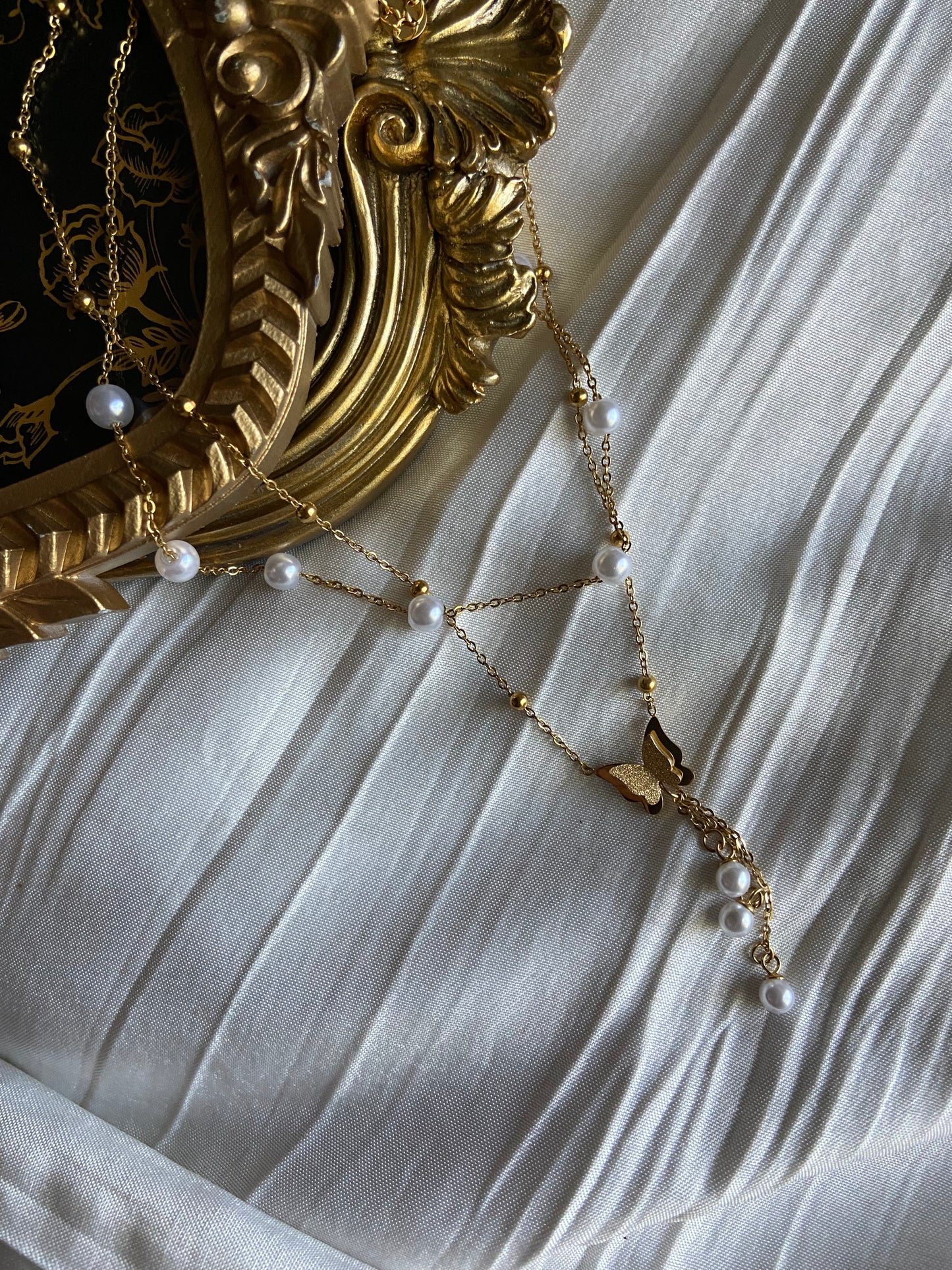 Multilayered gold pearl butterfly necklace