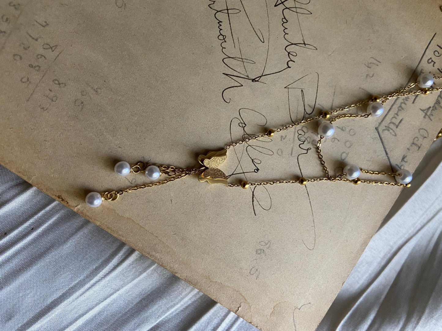 Multilayered gold pearl butterfly necklace