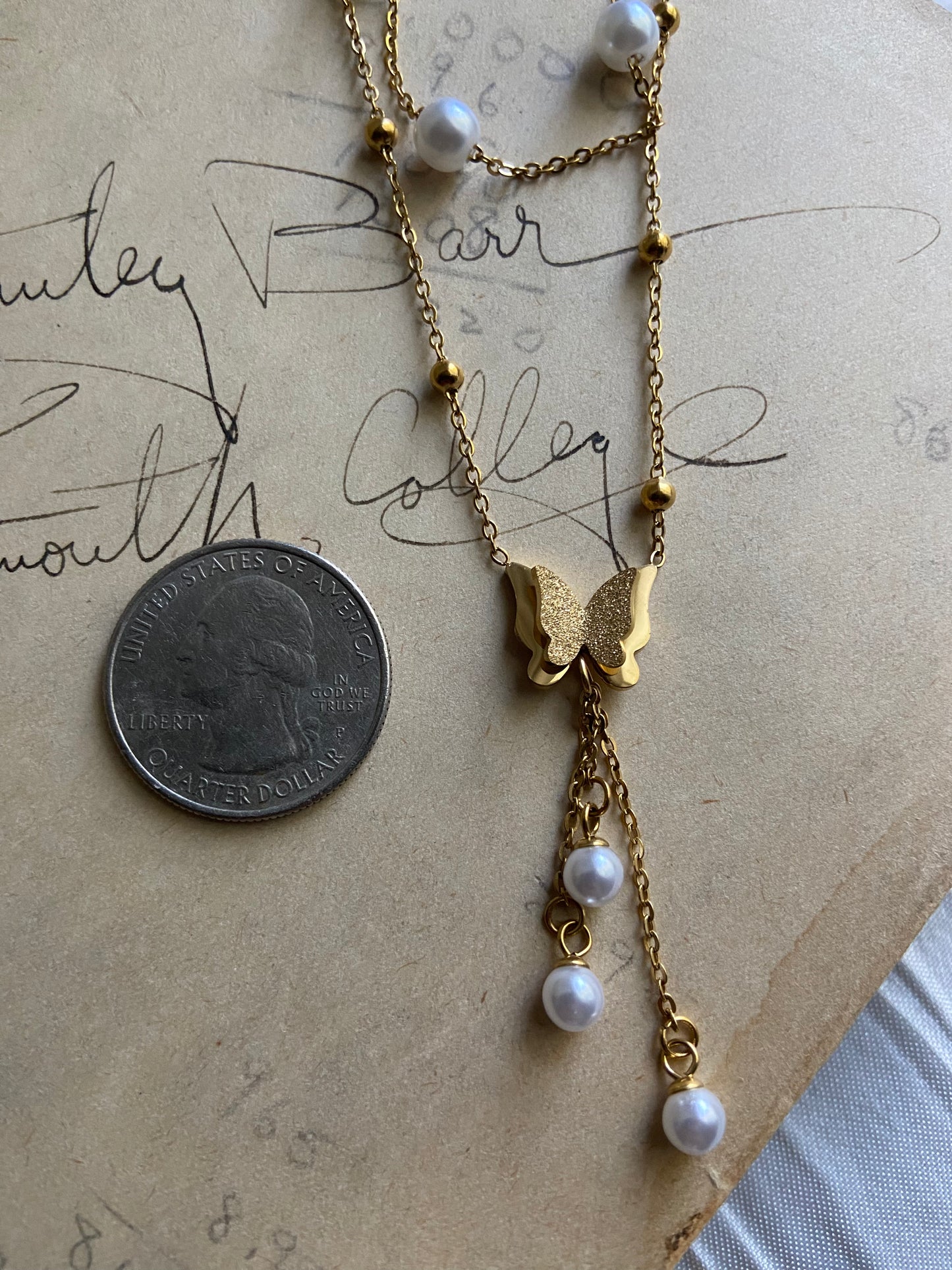 Multilayered gold pearl butterfly necklace